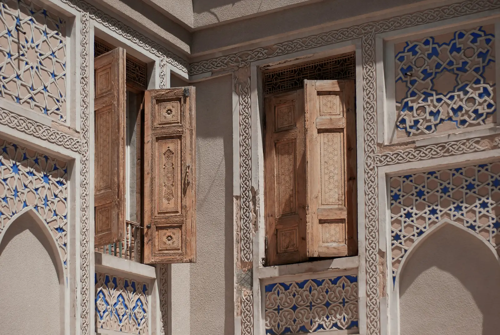 Carved wooden shutters and blue tilework, Khiva old city