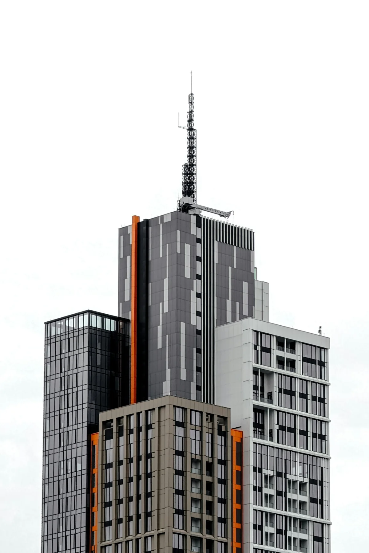 Modern tower with orange details against a clear sky, Tashkent